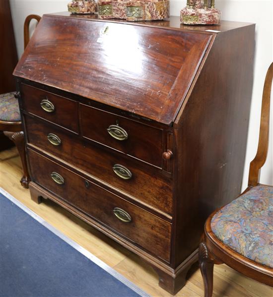 A George III mahogany bureau, with fitted interior, two short and two long drawers, W.107cm